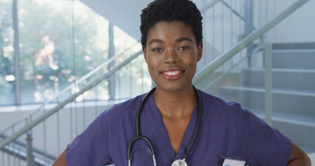 Portrait of happy african american female doctor smiling and looking at camera at hospital. Medicine, healthcare, lifestyle and hospital concept.