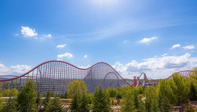 Amazing wooden roller coaster under bright blue sky
