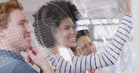 Team collaborating on interactive holographic interface using glass touchscreen