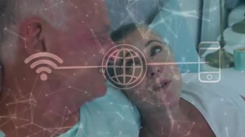 Senior Couple Communicating Digitally from Intimate Bedroom