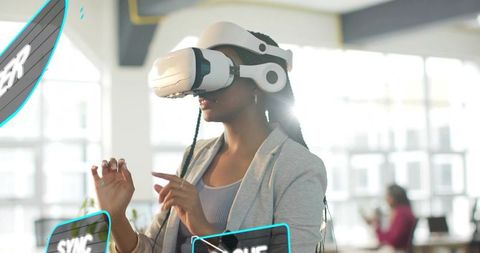 Businesswoman interacting with vr holographic interface in open-plan office collaboration
