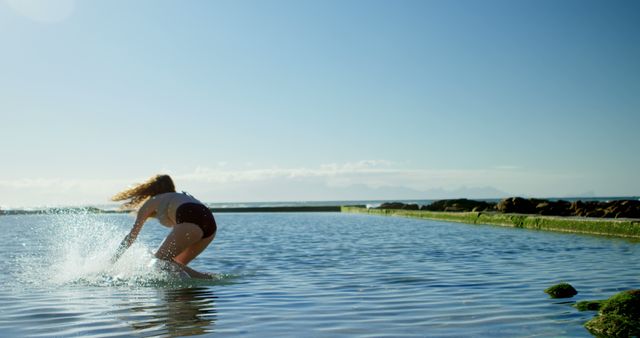 Woman standing on surfboard in shallow water near shore - Download Free Stock Images Pikwizard.com