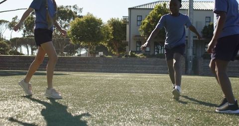 Teenagers sprinting on school artificial turf during outdoor pe and recess activities