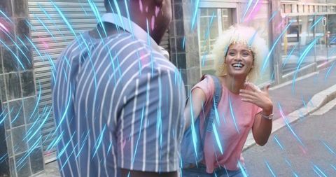 Joyful friends meeting on vibrant street with energetic light effects