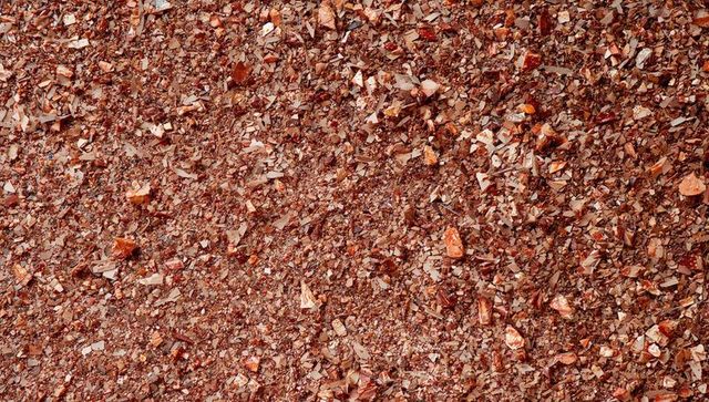 Rust-colored crushed rock and mineral chip texture for backgrounds and design