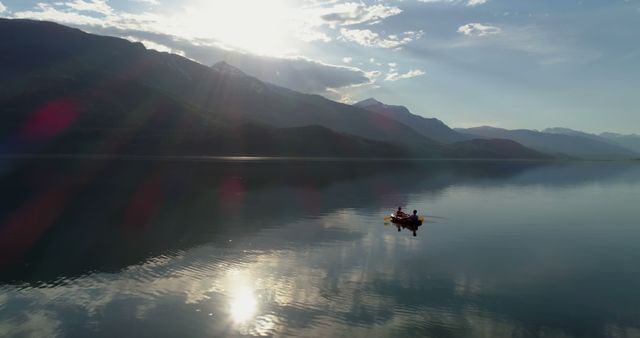 Sunrise Over Serene Mountain Lake with Lone Kayaker - Download Free Stock Images Pikwizard.com