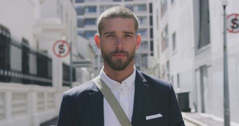 Confident caucasian businessman walking in urban environment