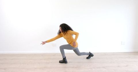 Woman expressing dance moves in bright minimalistic space