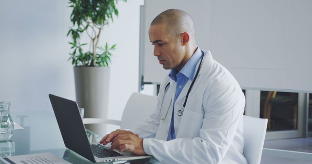 Focused Male Doctor in Clinic Using Laptop for Research - Download Free Stock Images Pikwizard.com