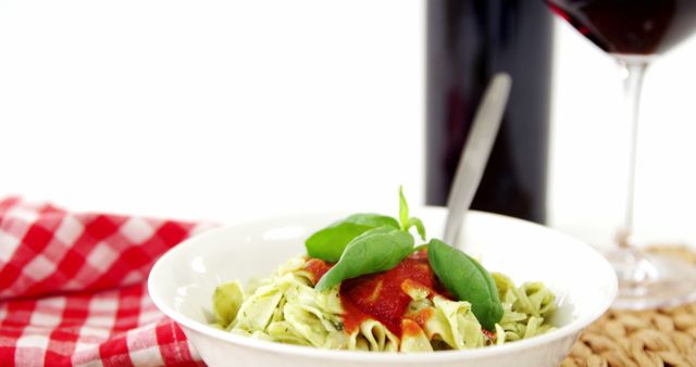 An Italian meal featuring pasta with tomato sauce and wine is ready for a gourmet experience. - Download Free Stock Photos Pikwizard.com