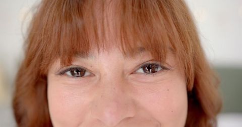 Close-Up of Young Woman with Brown Eyes and Subtle Smile