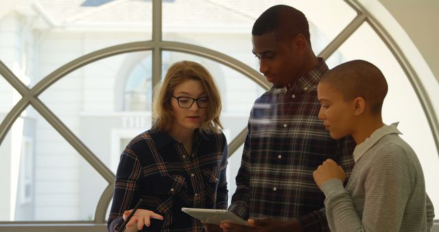 Diverse Young Adults Collaborating on Tablet in Bright Office - Download Free Stock Images Pikwizard.com