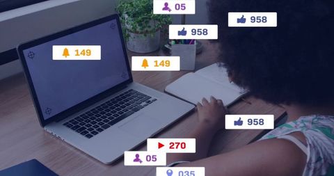 Woman working at laptop with social media notifications overlaying home workspace