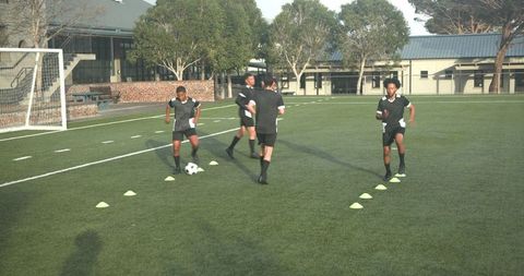 Soccer players engaging in passing drills to boost teamwork skills on field