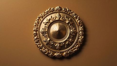Ornate Circular Gold Decorative Plate on Brown Wall
