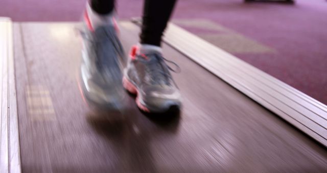 Close-up of feet running on treadmill in gym setting - Download Free Stock Images Pikwizard.com