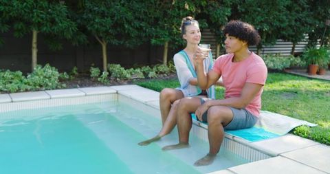 Couple Enjoying Relaxation by Backyard Pool with Drinks