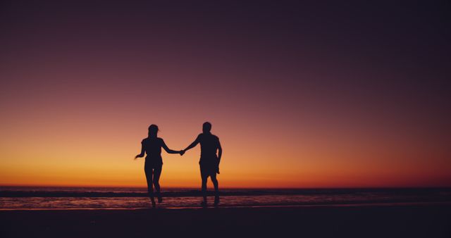 Couple Holding Hands by Ocean at Sunset in Silhouette - Download Free Stock Images Pikwizard.com