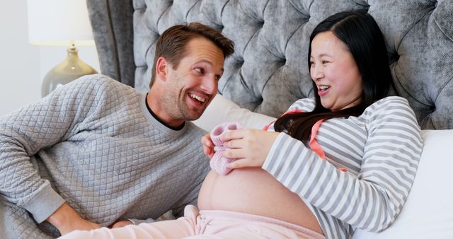 Smiling Couple Excitedly Prepping for Their Newborn - Download Free Stock Images Pikwizard.com