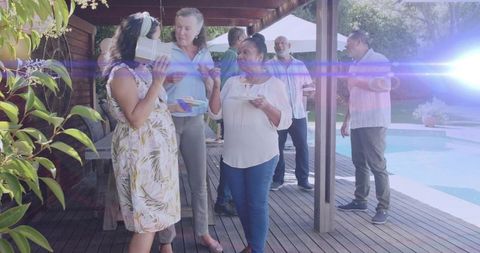 Celebrating poolside gift exchange during casual backyard summer gathering with friends
