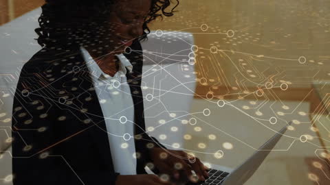 Businesswoman Using Laptop with Digital Circuit Overlay