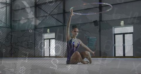 Teenage rhythmic gymnast mastering hoop artistry in gym