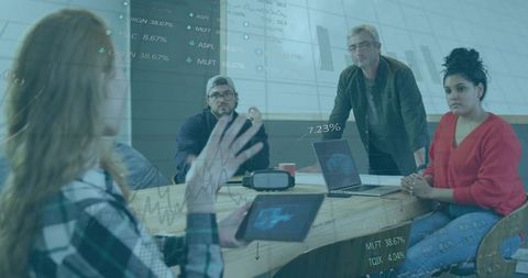 Collaborating Team Utilizing Technology in Modern Office Meeting