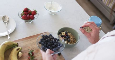 Hands Preparing Healthy Breakfast with Fruits and Granola - Download Free Stock Images Pikwizard.com