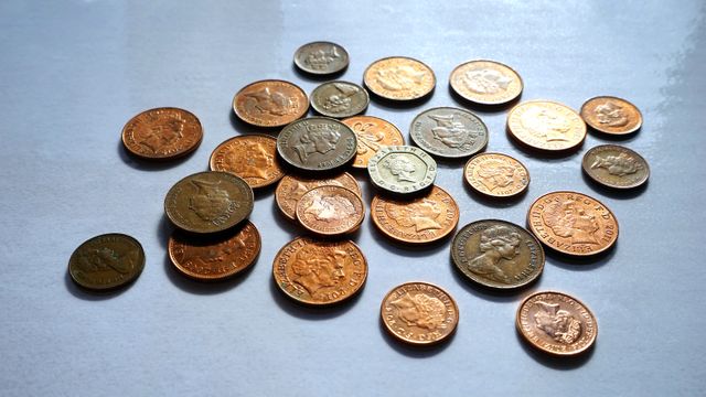 Scattered Mix of Shiny Coins on White Surface - Download Free Stock Photos Pikwizard.com