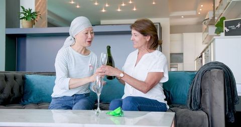 Senior Friends Celebrating Friendship with Champagne at Home