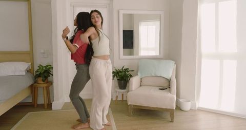 Diverse Female Friends Bonding in Comfortable Bedroom