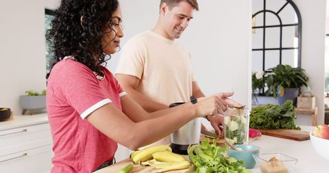 Couple Crafting Healthy Smoothie in Modern Kitchen