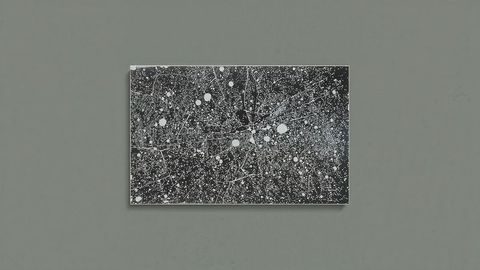 Abstract monochrome art with white splatter technique on black canvas