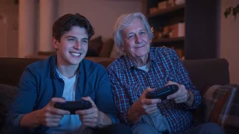 Grandfather and Grandson Playing Video Games Together on Couch During Cozy Evening