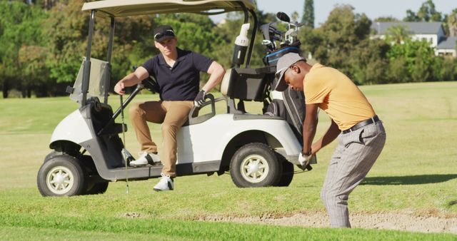 Image of diverse male friends playing golf on golf field. sporty, active lifestyle and playing golf concept.