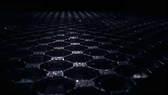 Glossy hexagonal honeycomb grid catching cool studio light with wet metallic highlights