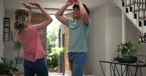 Young couple unpacking in new home, enjoying move-in day