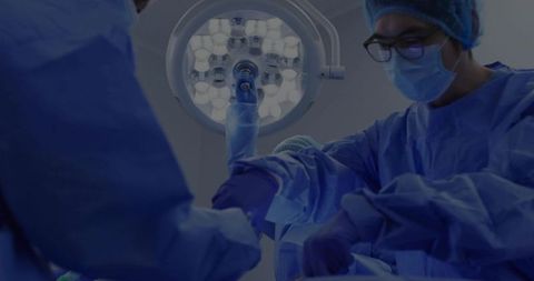 Asian Surgeon Performing Precise Surgery in Sterilized Operating Room