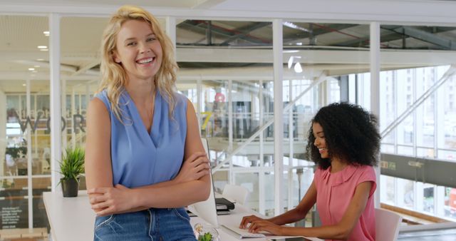 Two Diverse Women Smiling and Working in Modern Office - Download Free Stock Images Pikwizard.com