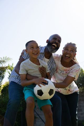 Joyful African American Family Bonding in Backyard