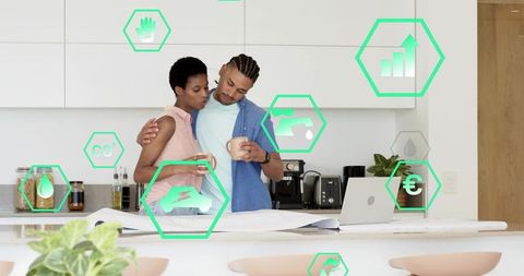 Young couple reviewing home renovation blueprints in modern kitchen with smart home icons
