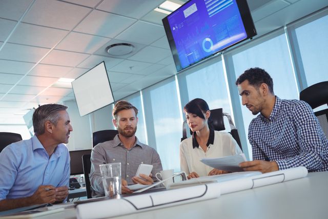 Tilt image of business people discussing at desk in office