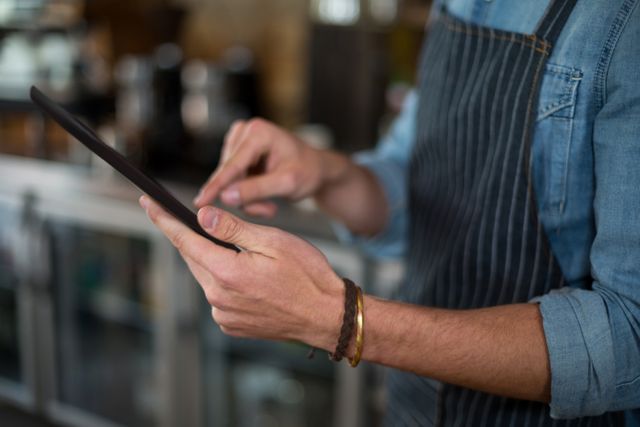 Waiter Using Digital Tablet in Café - Download Free Stock Images Pikwizard.com