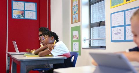 Diverse Students Engaged in Modern Classroom Learning Activities