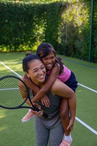 Mother and Daughter Bonding on Tennis Court