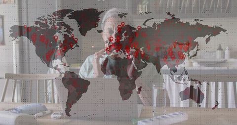 Senior Man Engaged in Global Data Analysis on Laptop