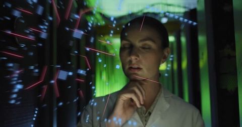 Researcher Analyzing Holographic Data Interface in Server Corridor with Futuristic UI