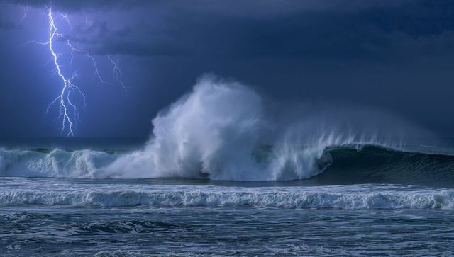 Lightning Strikes Over Mighty Ocean Wave