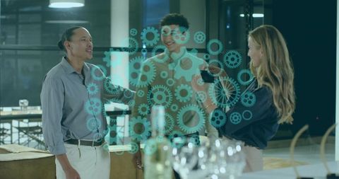 Multicultural professionals collaborating in modern workspace with teal gear overlay