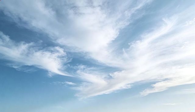 Wispy Cirrus Clouds Drifting Across Pale Blue Sky, Minimal Tranquil Atmosphere